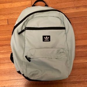 Adidas backpack. Light turquoise color. One big pocket, One medium, one small.